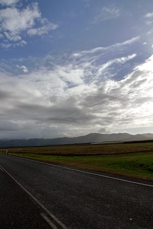 Clouds and blue sky above the Great Dividing Range, driving north