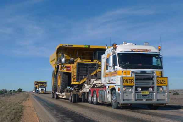 Oversize Semi Towing a Mining Truck in the Nullabor Desert