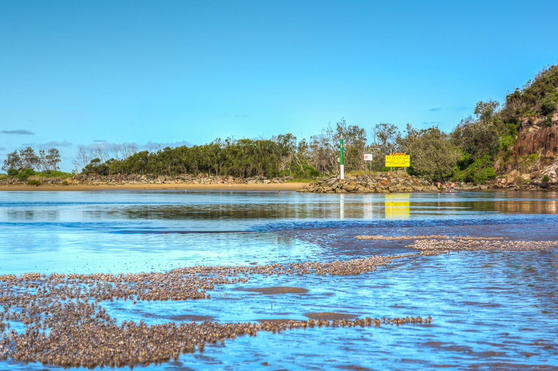 Wooli Wooli River at low tide, warning sign at mouth